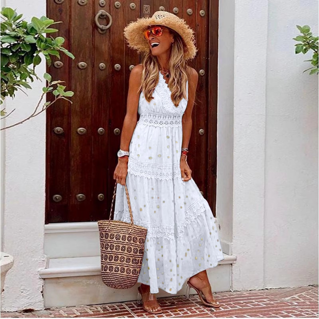 Woman in a white dress and straw hat standing in front of a wooden door.